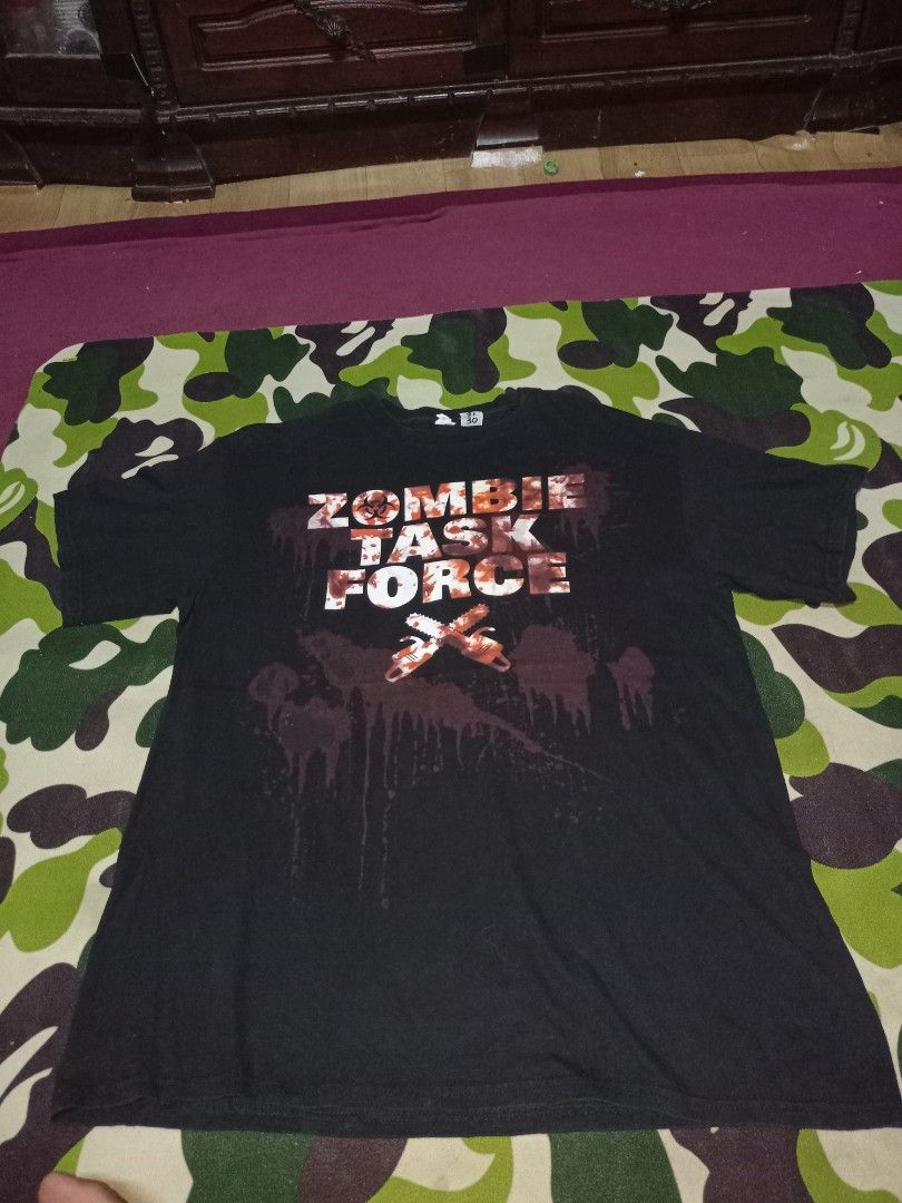 Zombie Task Force (Category: Tshirts & Polo Shirts) located in Kuala Terengganu. Submitted by babyshambles_strokes (Listing ID 1463942346, Image 3). Description: - Black t-shirt with 'Zombie Task Force' graphic - Features blood splatter and chainsaw design - Made from Data Pro Weight material - Tag size: 21 /30 - Ideal for horror and zombie enthusiasts.