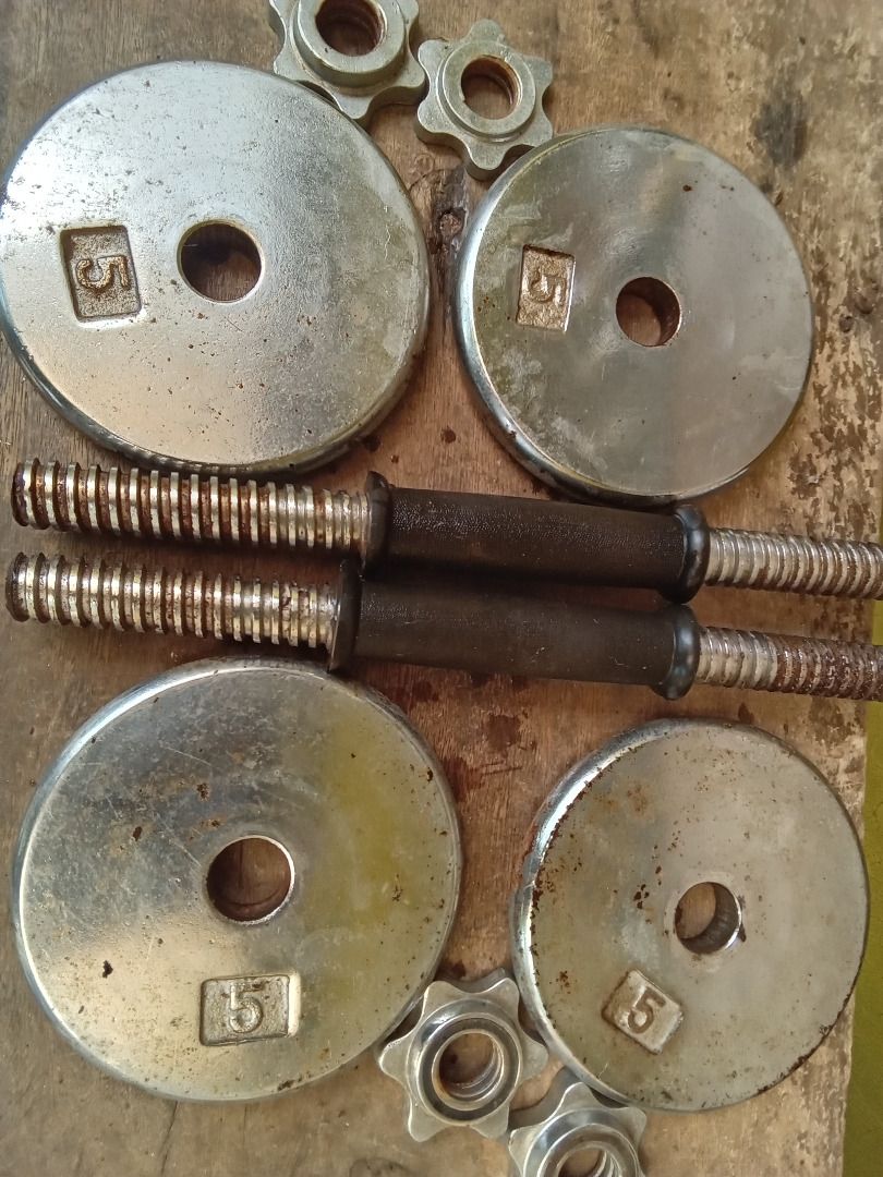 5kg Dumbbell Plates and Handles Set (Category: Weights & Dumbbells) located in Quezon City. Submitted by ppaya (Listing ID 1464157722, Image 1). Description: - Set includes: 2 dumbbell handles and 4 x 5kg weight plates. - Plates feature a silver finish and are clearly marked with '5'. - Handles have a textured grip for secure and comfortable handling. - Minor signs of wear on plates and handles, but fully functional. - Ideal for effective home wo