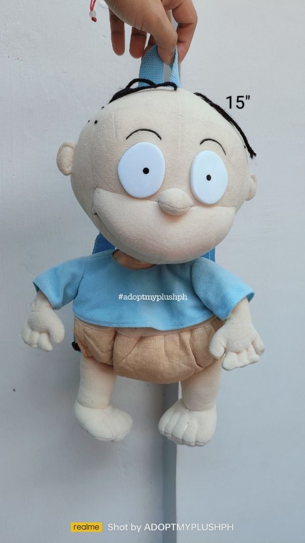 90s Rugrats, Tommy Pickles Plush Backpack (Category: Plushies & Soft Toys) located in Taguig. Submitted by adopt.my.plush.ph (Listing ID 1464303403, Image 1). Description: Tommy Pickles plush backpack features his classic light blue shirt and diaper with comfortable over-the-shoulder straps Character: Tommy Pickles, depicted in his classic light blue t-shirt and tan diaper. Type: Combination stuffed toy and functional novelty backpack, featuring 