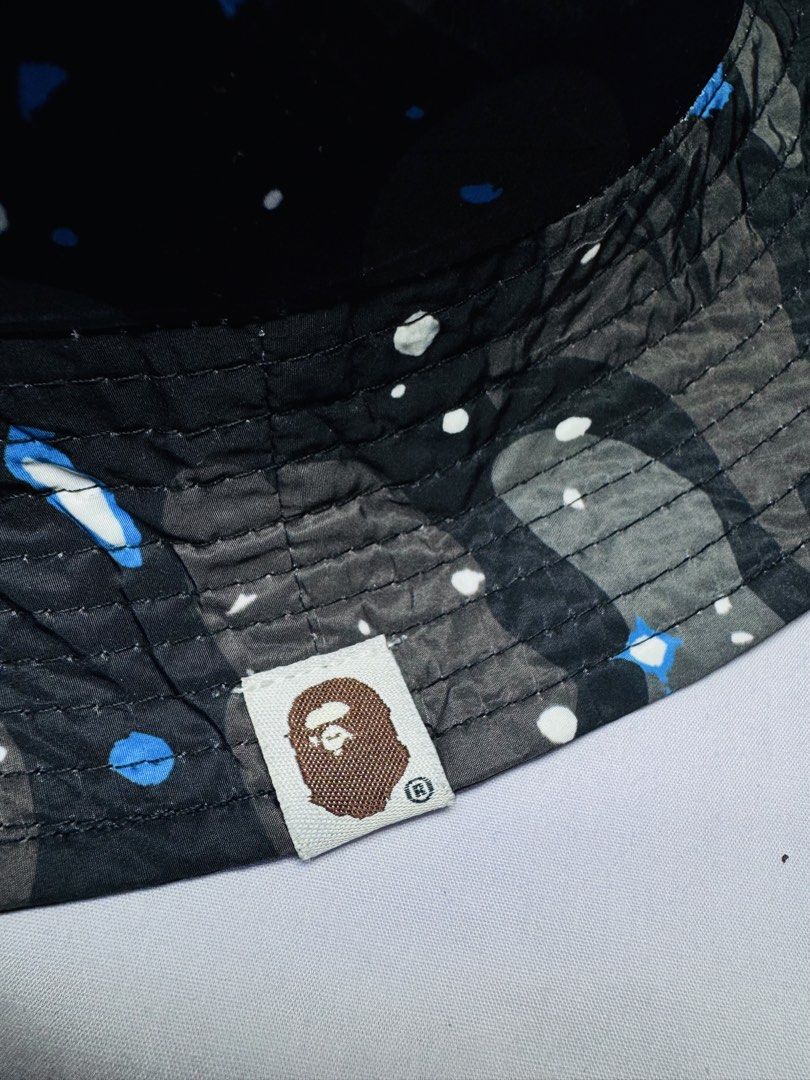 A Bathing Ape BAPE Camo Bucket Hat (Category: Caps & Hats) located in Roxas City. Submitted by patsquarephantz (Listing ID 1464308173, Image 3). Description: - Classic BAPE camo bucket hat - Features iconic ape head logo - Mesh detailing around the crown for breathability - Unique blue and white camo pattern - Ideal for sunny days and streetwear outfits - A must-have for streetwear enthusiasts.