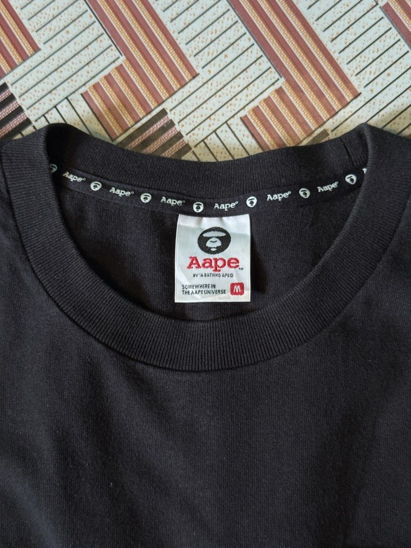 AAPE BY A BATHING APE Black Pocket Tee (Category: Tshirts & Polo Shirts ) located in Cagayan de Oro. Submitted by thrifteecdo (Listing ID 1464201713, Image 3). Description: - Black Aape T-shirt (Long back design) - 9/10 color rate. Excellent condition - Dimes ; Width- 22 inches Front length- 26 inches Back length- 28 inches - Chest pocket with Aape logo - Aape logo repeated on sleeve cuff - Aape branding along bottom hem - 100% Cotton - Tagged Si