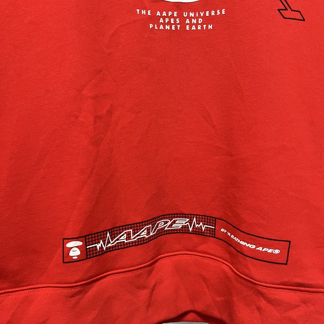 AAPE BY A BATHING APE Red Graphic Sweatshirt (Category: Coats, Jackets and Outerwear) located in Manila. Submitted by alexanderm59285 (Listing ID 1464264789, Image 3). Description: - Red AAPE sweatshirt - Features AAPE Universe apes and planet Earth graphic print - "PLANET EARTH" text on the sides - Zipper details on side seams - Ideal for casual wear.