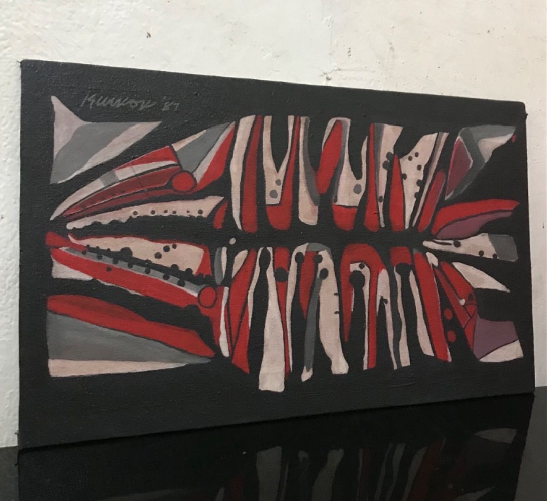 Abstract Painting (Category: Art & Prints) located in Quezon City. Submitted by angeloolarte1 (Listing ID 1464290265, Image 2). Description: - Original abstract artwork signed by en dated '87. - Features a striking geometric design. - Colors: Red, white, and grey on a black background. - Medium: Canvas board with wooden backing. - A unique piece for your art collection..