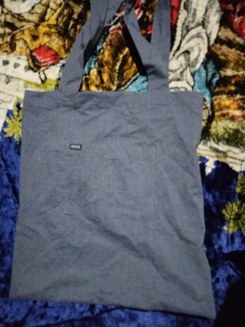 Adar Tote Bag (Category: Tote Bags) located in Mabalacat. Submitted by al_amin_thrift (Listing ID 1464229435, Image 3). Description: 🛍️ ADAR Chambray Tote Bag — Slate Blue Item Details - Brand: ADAR — known for professional & lifestyle apparel ​ - Style: Everyday shoulder tote ​ - Material: Lightweight, soft-woven chambray cotton — breathable & durable ​ - Color: Muted slate blue / heathered denim tone with bright blue "ADAR" lettering ​ - Featu