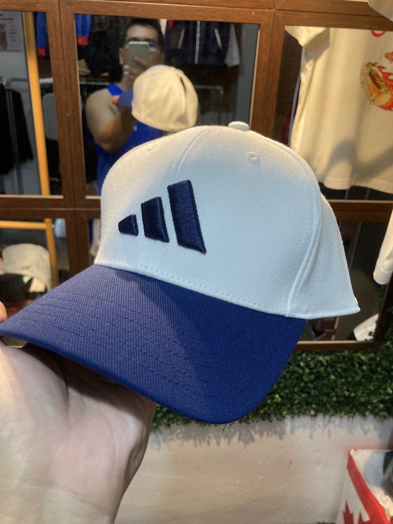Adidas Baseball Cap M/L White Blue (Category: Caps & Hats) located in Trece Martires City. Submitted by thriftkoto.91 (Listing ID 1464217251, Image 1). Description: - Brand: Adidas - Style: Baseball Fitted Cap - Color: White with Blue Brim and Logo - Size: M/L (fits 56-59cm) - Origin: Made in Vietnam - Condition: Brand New with Original Tag Attached - Original Retail Price: PHP 1,400.00.