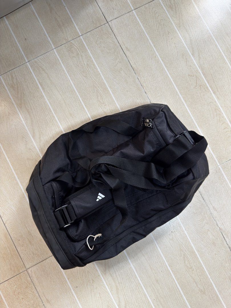 Adidas Black Duffel Bag with 3 Stripes (Category: Sling Bags) located in Pasig City. Submitted by brosotocrysthel17 (Listing ID 1464172892, Image 2). Description: - Classic black Adidas duffel bag - Iconic 3 stripes logo - Perfect size for gym sessions or short getaways - Multiple pockets for organized storage - Adjustable shoulder strap for comfortable carrying - Made with durable material - Ready for your next adventure!.