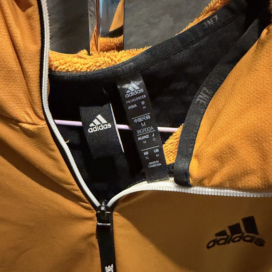 Adidas Orange Fleece Lined Hoodie Jacket (Category: Coats, Jackets and Outerwear) located in Manila. Submitted by iceonmyneck (Listing ID 1464246735, Image 2). Description: - Orange Adidas hoodie jacket - Black accents on shoulders and back - Fleece lined for extra warmth - Full zip closure with pockets - Size M - Ideal for cooler weather - In perfect Condition.