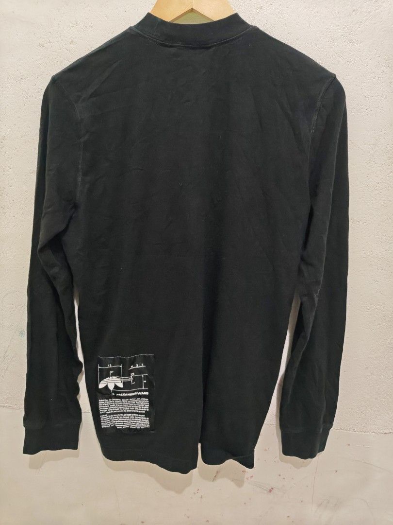 Adidas x Alexander Wang Long Sleeve Tee (Category: Activewear) located in Isulan. Submitted by jaysthrift (Listing ID 1464216781, Image 2). Description: - Adidas x Alexander Wang collaboration - Black long sleeve t-shirt - Features text and graphic details on the front - Small graphic patch on the back - Made in Turkey - Model number: CV5290 -20x27.