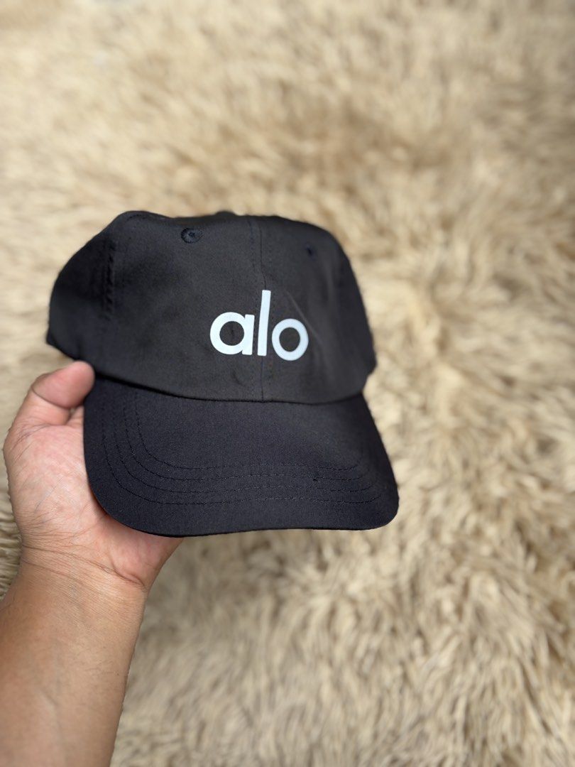 Alo Black Baseball Cap (Category: Caps & Hats) located in Quezon City. Submitted by nojthrift (Listing ID 1464252700, Image 2). Description: - Brand: Alo - Color: Black - Design: Classic baseball cap with Alo logo on front - Features: Adjustable strap at the back for a customized fit - Ideal for: Everyday wear, workouts, or casual outings.