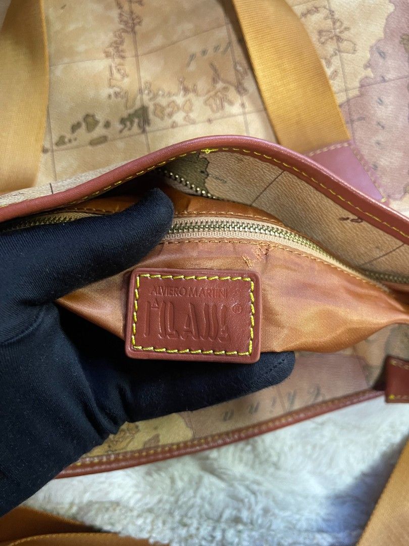 Alviero Martini Map Bag Two way Large (Category: Cross-body Bags) located in Naawan. Submitted by twillycalledprelovedbags (Listing ID 1464138130, Image 3). Description: no COD issue may konting scratch sa bottom sa leather, and change Ang puller sa loob large size in nice condition.