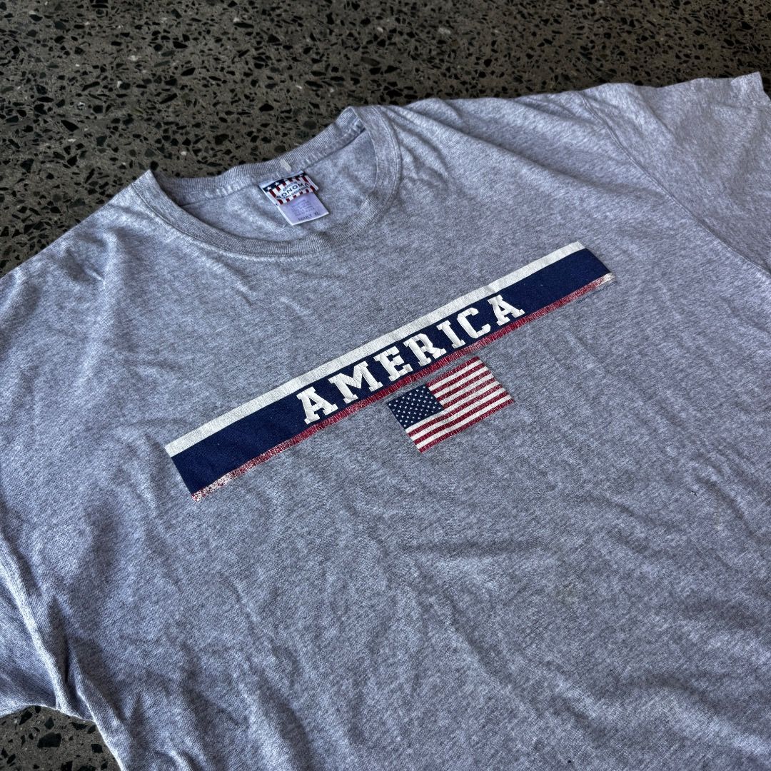 AMERICA (Category: Tshirts & Polo Shirts ) located in Quezon City. Submitted by theq.thriftshop (Listing ID 1464147378, Image 3). Description: PLEASE READ FIRST! MINE ₱349 + sf (FIXED) Size XL (L 26.5”, W 23”) Issues: Cracked print, tiny hole Color may vary due to lighting Model’s height: 5’9 💸 G-Cash payment 📦 J&T Nationwide shipping.