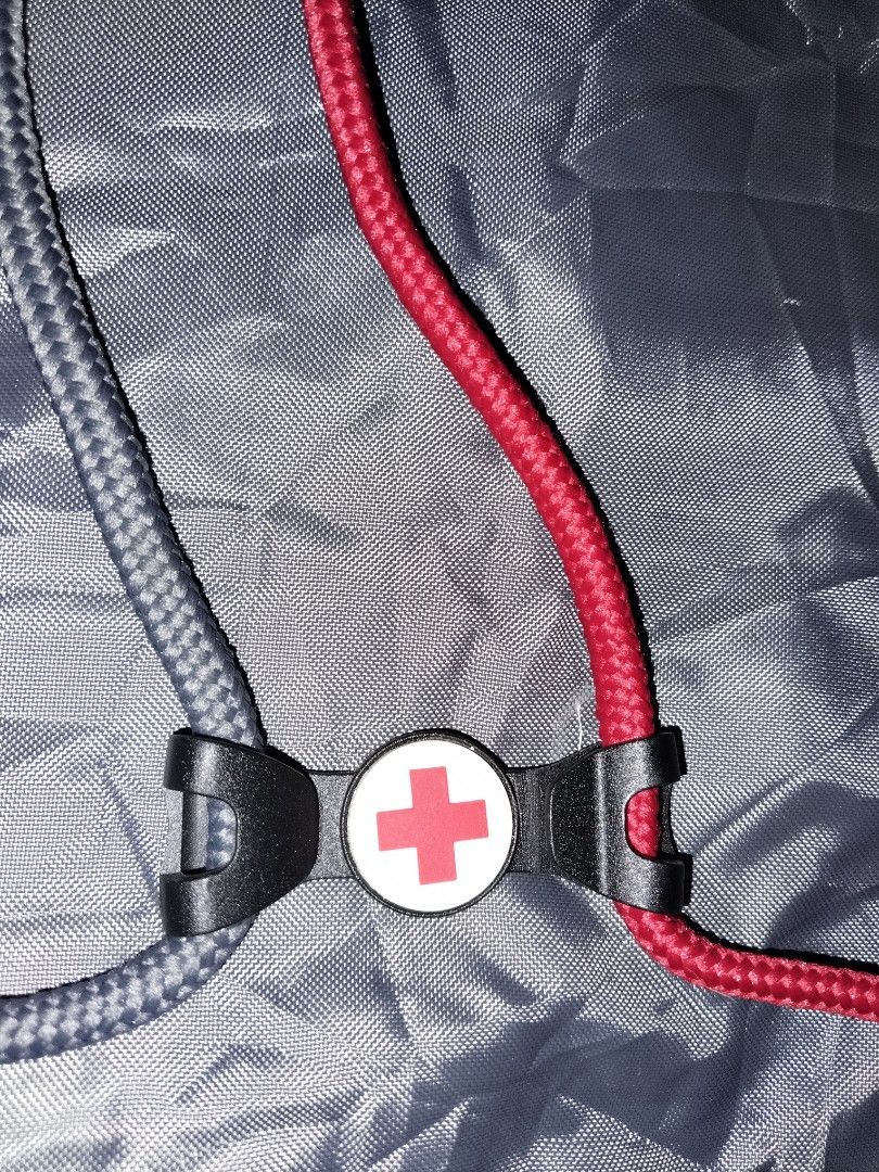 American Red Cross Drawstring Backpack (Category: Backpacks) located in Mabalacat. Submitted by al_amin_thrift (Listing ID 1464227454, Image 2). Description: 🎒 American Red Cross Drawstring Backpack Item Details - Front: Bright red with official white Red Cross logo + "American Red Cross" lettering ​ - Back: Sleek dark gray / charcoal ​ - Straps: Dual drawstring — one red, one gray — doubles as shoulder straps ​ - Material: Lightweight, smooth, 