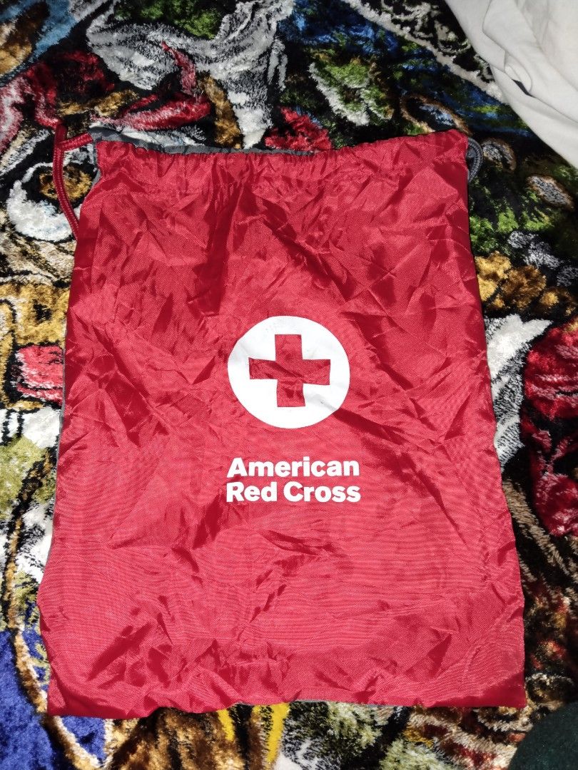 American Red Cross Drawstring Backpack (Category: Backpacks) located in Mabalacat. Submitted by al_amin_thrift (Listing ID 1464227454, Image 1). Description: 🎒 American Red Cross Drawstring Backpack Item Details - Front: Bright red with official white Red Cross logo + "American Red Cross" lettering ​ - Back: Sleek dark gray / charcoal ​ - Straps: Dual drawstring — one red, one gray — doubles as shoulder straps ​ - Material: Lightweight, smooth, 