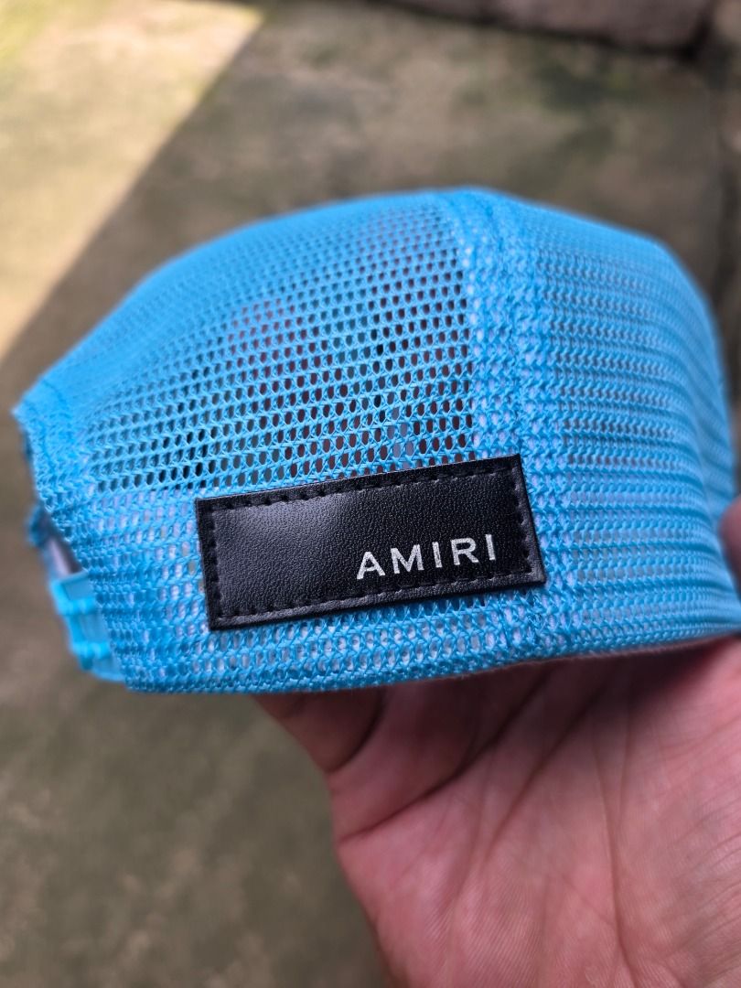 AMIRI Pegasus Blue Trucker Cap (Category: Caps & Hats) located in Santa Maria. Submitted by purefalcon-f7cf (Listing ID 1464276953, Image 2). Description: - Light blue AMIRI trucker cap - Features embroidered text: 'AMIRI ENGINEERED 2023 LOS ANGELES CALIFORNIA DREAMERS' - Breathable mesh back - Adjustable snap closure for a custom fit - Made in USA - Materials sourced from Italy - Composition: 98% Cotton, 2% Elastane.