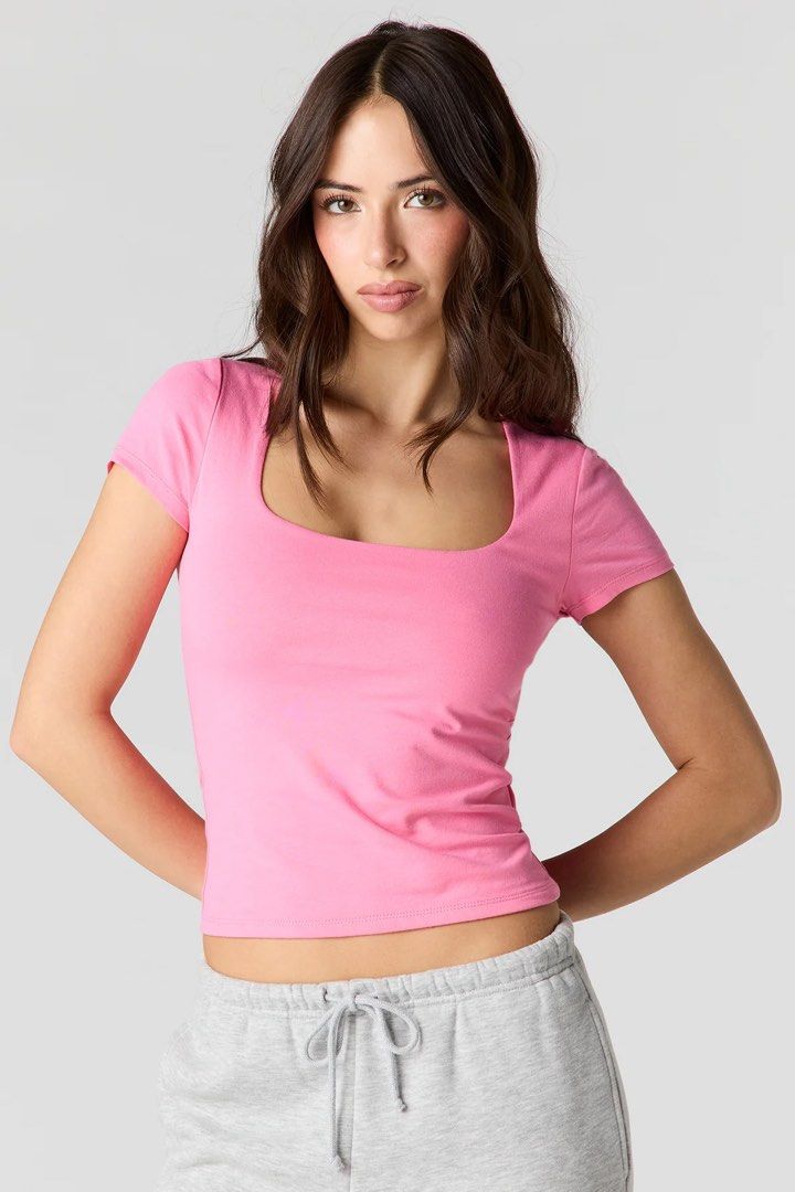 Amisu Baby Pink Squareneck Double Lining Top (Category: Others Tops) located in Binan City. Submitted by myprelovedhaul (Listing ID 1464151543, Image 2). Description: This is an Amisu square-neck semi-cropped top in a solid bubblegum pink color. It features a distinctive wide square neckline, short sleeves, and is crafted from a stretchable, body-hugging fabric that typically includes a supportive double lining..