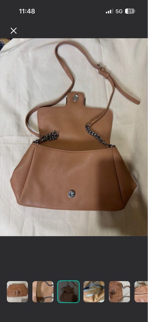 Andiata Sling Bag (Category: Shoulder Bags) located in Makati City. Submitted by issa124 (Listing ID 1464302637, Image 3). Description: - Brown textured leather shoulder bag - Silver geometric clasp closure on front flap - Interior zippered pocket and slip pocket - Silver chain strap - Can be worn as a shoulder bag or a clutch - Versatile for day or night use - Original Andiata Sling Bag. Like new. See pictures to appreciate. No issues. Usually p