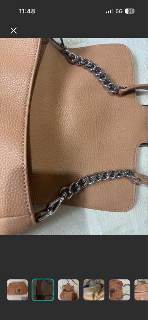 Andiata Sling Bag (Category: Shoulder Bags) located in Makati City. Submitted by issa124 (Listing ID 1464302637, Image 2). Description: - Brown textured leather shoulder bag - Silver geometric clasp closure on front flap - Interior zippered pocket and slip pocket - Silver chain strap - Can be worn as a shoulder bag or a clutch - Versatile for day or night use - Original Andiata Sling Bag. Like new. See pictures to appreciate. No issues. Usually p