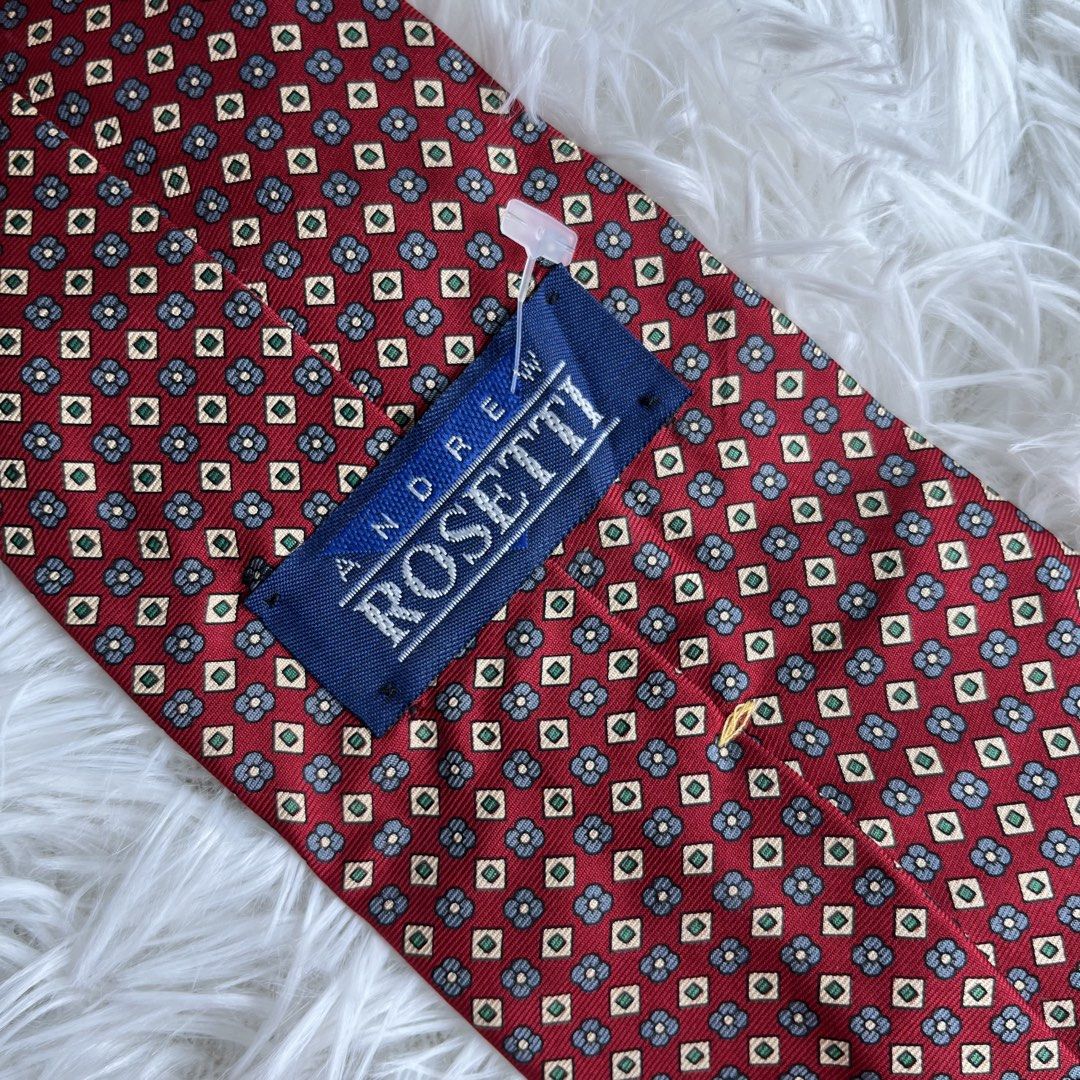 Andrew Rosetti Silk Tie (Category: Ties) located in Cuyapo. Submitted by Ashtyn.Pre.Loved (Listing ID 1464195671, Image 2). Description: - Brand: Andrew Rosetti - Material: Silk - Color: Deep red base - Pattern: Repeating geometric floral (blue, yellow, green) - Occasion: Formal events, adding color to outfits.
