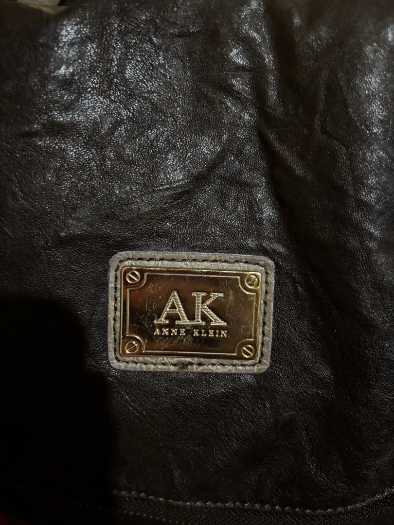 Anne Klein Brown Leather Shoulder Bag (Category: Shoulder Bags) located in Caloocan City. Submitted by _avionlineshop24 (Listing ID 1464138405, Image 2). Description: - Brand: Anne Klein - Color: Brown/ Bronze - Material: Textured Leather - Style: Slouchy Shoulder Bag - Features: Long adjustable strap, multiple interior compartments - Condition: Good, with minor signs of wear on zipper pull and leather.