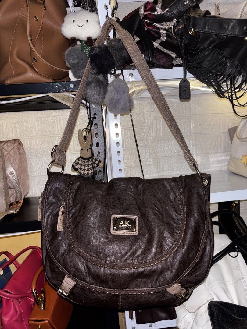 Anne Klein Brown Leather Shoulder Bag (Category: Shoulder Bags) located in Caloocan City. Submitted by _avionlineshop24 (Listing ID 1464138405, Image 1). Description: - Brand: Anne Klein - Color: Brown/ Bronze - Material: Textured Leather - Style: Slouchy Shoulder Bag - Features: Long adjustable strap, multiple interior compartments - Condition: Good, with minor signs of wear on zipper pull and leather.
