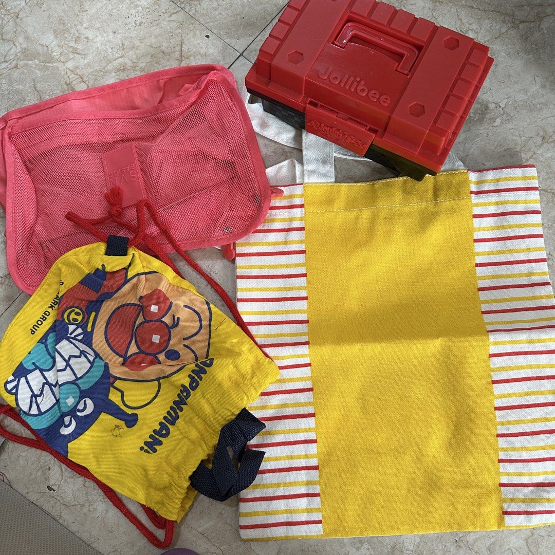 Anpanman Drawstring Pouch, Pink Mesh Pouch, Striped Tote Bag (Category: Purses & Pouches) located in Kawit. Submitted by wevibevintage (Listing ID 1464191318, Image 1). Description: - Set of 3 versatile bags - Includes a cute yellow Anpanman drawstring pouch - Features a practical pink mesh pouch with a zipper - Comes with a stylish canvas tote bag with yellow, red, and white stripes - Tote bag has a large, convenient yellow front pocket - Ideal 