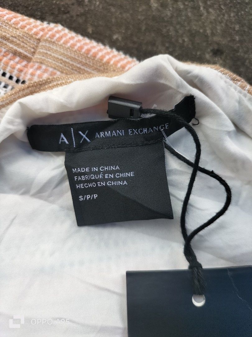 Armani Exchange Sleeveless Zip Front Textured Top S (Category: Sleeveless) located in Manila. Submitted by john_erwin_dollaga_cafe (Listing ID 1464293588, Image 2). Description: - Armani Exchange sleeveless top - Textured fabric with horizontal stripes (peach, white, blue) - Zip front detail - Size: S - Made in China - Original tags attached.