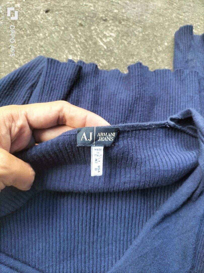Armani Jeans Navy Blue Ribbed V-Neck Sweater (Category: Longsleeves) located in Manila. Submitted by john_erwin_dollaga_cafe (Listing ID 1464254021, Image 2). Description: - Brand: Armani Jeans - Color: Navy Blue - Style: Long-sleeved V-neck sweater - Material: Ribbed knit fabric - Features: Armani Jeans logo on sleeve - Size: 42 Italy / 8 USA - Versatile: Great for layering or wearing solo.