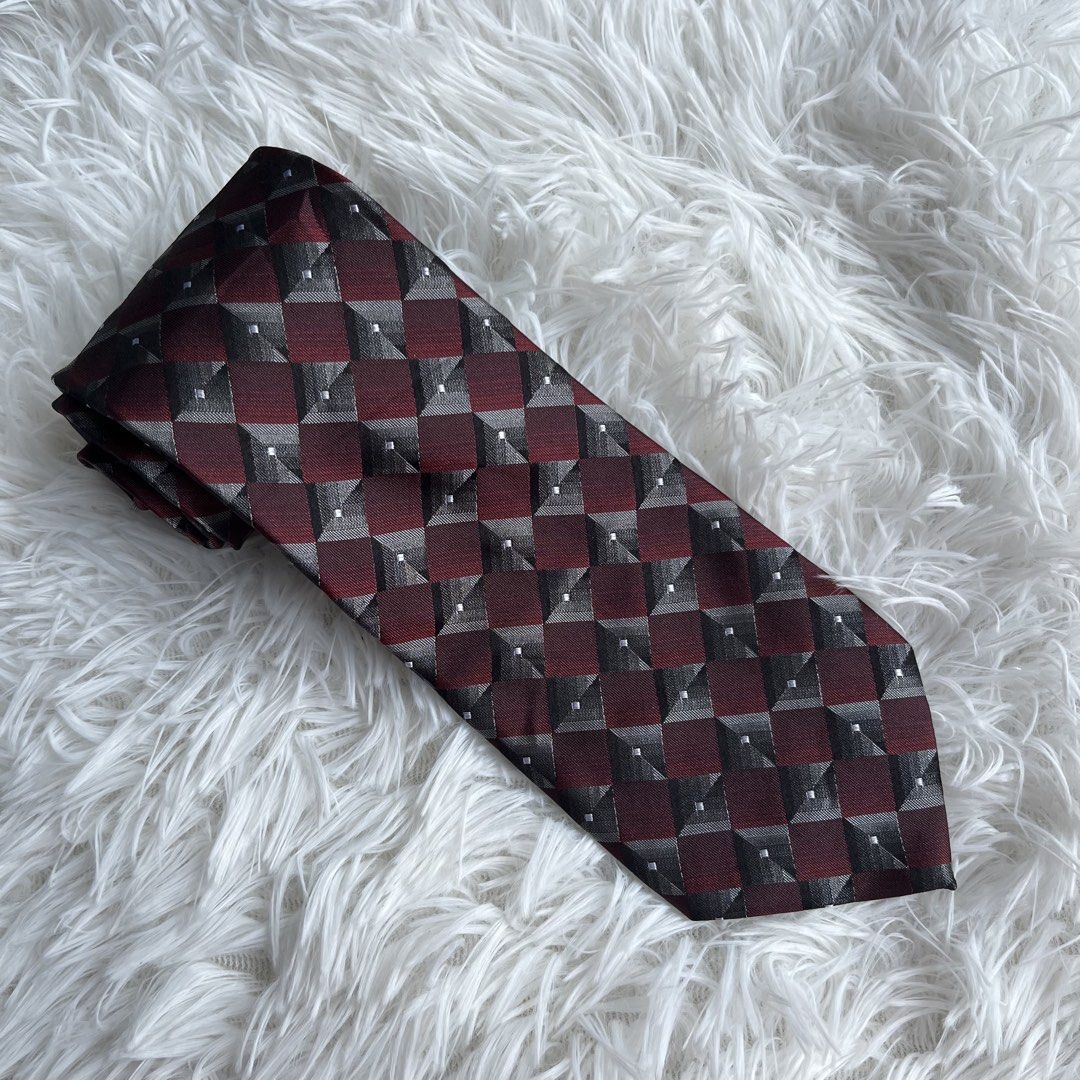 Arrow Men's Geometric Pattern Tie (Category: Ties) located in Cuyapo. Submitted by Ashtyn.Pre.Loved (Listing ID 1464196035, Image 1). Description: - Classic Arrow tie - Features a cool geometric pattern - Colors: Deep red, black, and silver - Made from quality material - Perfect for work or special occasions - A stylish addition to any wardrobe.