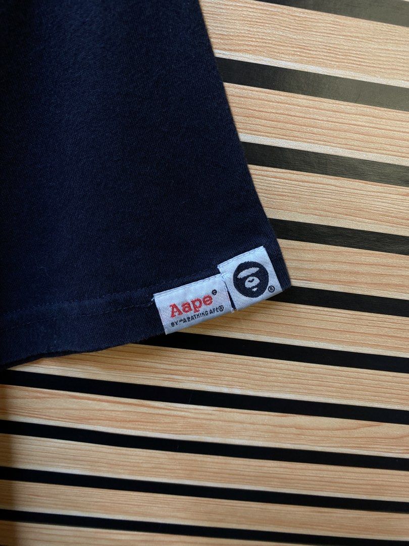 AUTHENTIC AAPE “APUNVS” TEE (Category: Tshirts & Polo Shirts ) located in Makati City. Submitted by drip.poww (Listing ID 1464228708, Image 3). Description: - Authentic Aape - Color: Black - Size: Meduim - Dimes: 20x26 - Authentic - Excellent condition - Need wash, fresh from bale - Material: 100% Cotton Please don’t expect too much—these are thrifted (ukay) items. 😊 !!STILL NEGOTIABLE!!.