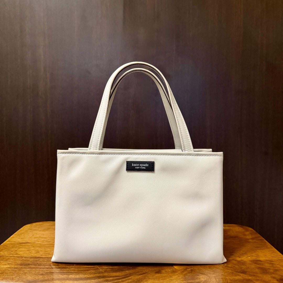 [Authentic] Kate Spade Sam Icon Nylon Small Tote (Category: Luxury Bags & Wallets) located in Caloocan City. Submitted by margarette8 (Listing ID 1464327248, Image 2). Description: ‼️ FOR SALE ‼️ [Authentic] Kate Spade Sam Icon Nylon Small Tote SALE price: 6,000PHP (SLIGHTLY negotiable) • Bought at Rustan's • Original Price: 16,950PHP • Color: STONY BEACH (Silver hardware) • Type: Top Handle Bag/Crossbody Bag - handle drop: 4.5" | strap drop: 22"