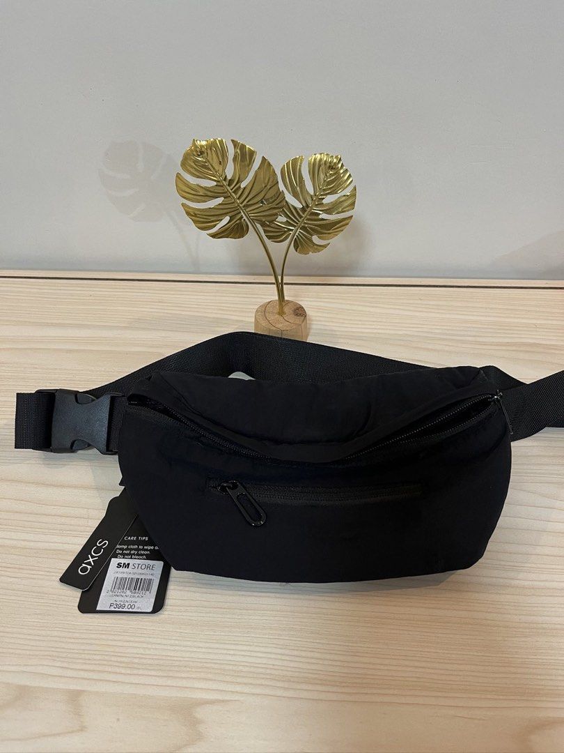 AXCS Black Fanny Pack (Category: Belt bags, Clutches and Pouches) located in Paranaque City. Submitted by sissyloveph (Listing ID 1464287608, Image 1). Description: - Brand: AXCS - Color: Black - Features: Main zippered compartment, front zippered pocket - Strap: Adjustable with buckle closure - Condition: Brand new with tags attached - Purchase Location: SM Store.