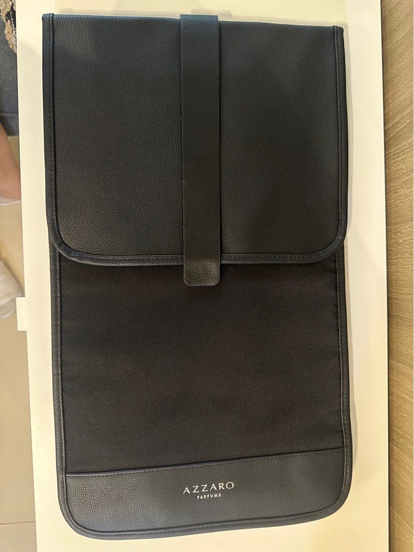 Azzaro Perfums Black Travel Bag Organizer (Category: Luxury Bags & Wallets) located in Manila. Submitted by kevintotin49861 (Listing ID 1464160936, Image 2). Description: - Brand: Azzaro Perfums - Color: Black - Material: Faux leather exterior, fabric interior - Features: Back straps (potential backpack style), folds open, snap closure - Ideal for: Organizing toiletries or makeup during travel - Design: Clean and simple.