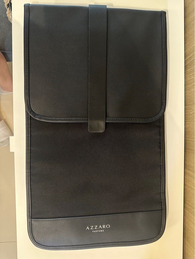 Azzaro Perfums Black Travel Bag Organizer (Category: Luxury Bags & Wallets) located in Manila. Submitted by kevintotin49861 (Listing ID 1464160936, Image 1). Description: - Brand: Azzaro Perfums - Color: Black - Material: Faux leather exterior, fabric interior - Features: Back straps (potential backpack style), folds open, snap closure - Ideal for: Organizing toiletries or makeup during travel - Design: Clean and simple.