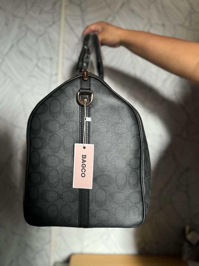 BAGCO Monogram Duffel Bag (Category: Tote Bags) located in Manila. Submitted by vsballeras1984 (Listing ID 1464197879, Image 3). Description: - Brand: BAGCO - Type: Monogram Duffel Bag - Color: Black - Features: All-over pattern, top handles, detachable shoulder strap - Ideal for: Travel, gym - Size: Approximately 18 inches long - Condition: Brand new with tag attached.