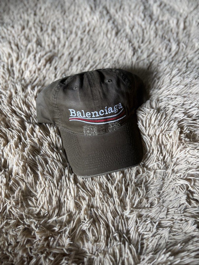 Balenciaga Logo Cap (Category: Caps & Hats) located in Quezon City. Submitted by nojthrift (Listing ID 1464251964, Image 1). Description: - Authentic Balenciaga cap - Color: Dark Green/Khaki - Classic Balenciaga logo embroidery on front - Distressed detailing on brim - Adjustable strap at the back for a custom fit - Ideal for everyday styling.