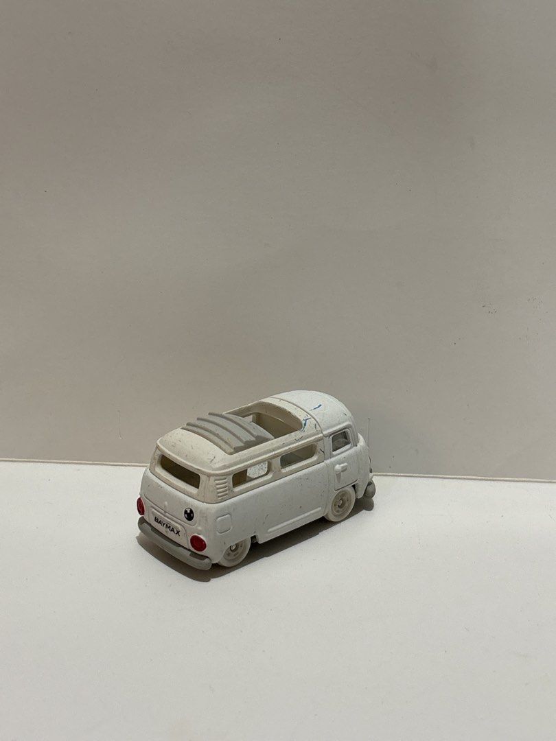 Baymax Tomica Loose (Category: Vehicle & Diecast Models) located in Cavite. Submitted by eleanordc (Listing ID 1464310885, Image 2). Description: - White toy Volkswagen Kombi van - Features a sunroof - Back reads 'BAYMAX' - Wheels spin freely - Minor paint scuffs present - Perfect for collectors or as a toy.