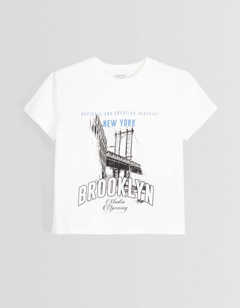 Bershka Brooklyn Printed Shirt (Category: Shirts) located in Binan City. Submitted by myprelovedhaul (Listing ID 1464165064, Image 2). Description: This appears to be a white graphic T-shirt from Bershka featuring a New York Brooklyn Bridge design..