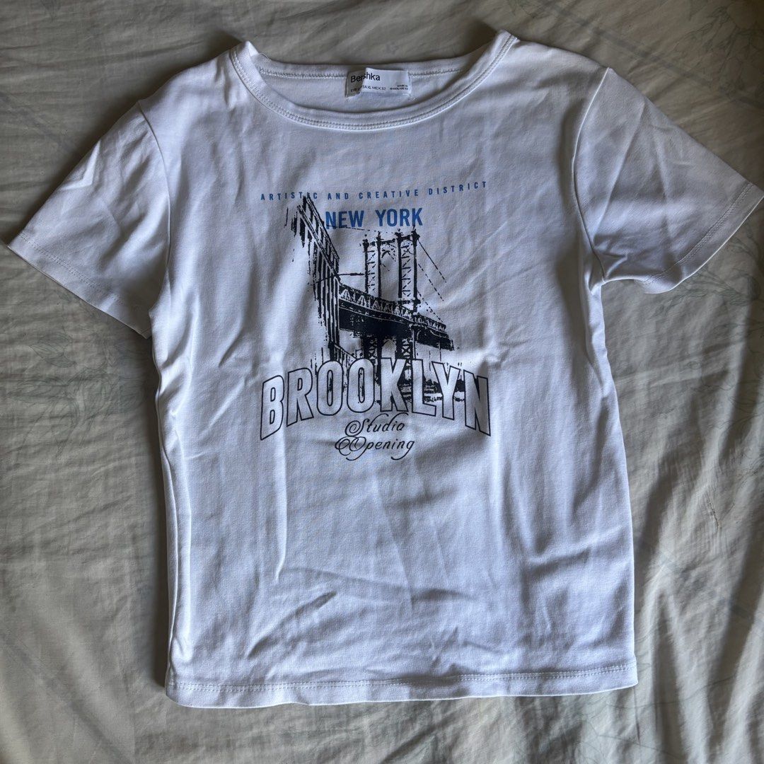 Bershka Brooklyn Printed Shirt (Category: Shirts) located in Binan City. Submitted by myprelovedhaul (Listing ID 1464165064, Image 3). Description: This appears to be a white graphic T-shirt from Bershka featuring a New York Brooklyn Bridge design..