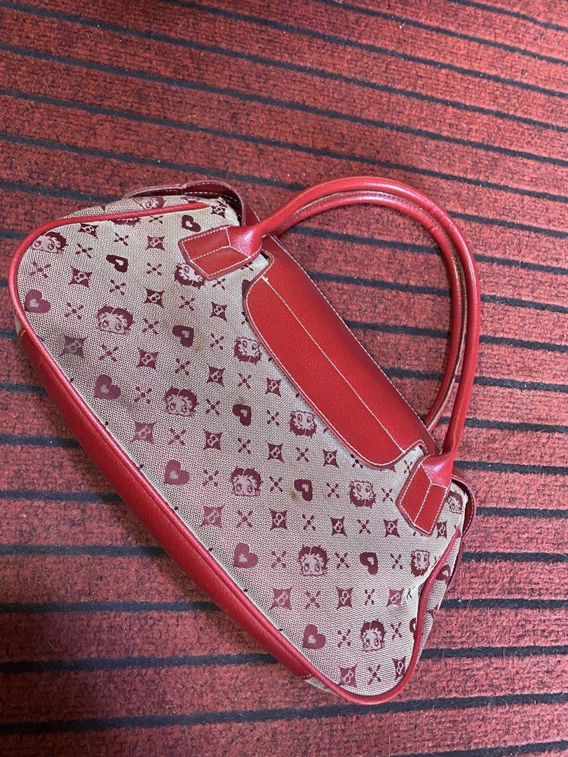 Betty Boop Monogram Canvas & Leather Handbag (Category: Luxury Bags & Wallets) located in Calamba. Submitted by curlybang (Listing ID 1464143240, Image 2). Description: - Adorable Betty Boop print handbag - Features red leather trim and handles - Secure zipper closure - Fun monogram pattern with hearts and Betty Boop faces - Perfect for daily use or as a stylish accessory - Shows some signs of wear, but still in good usable condition.