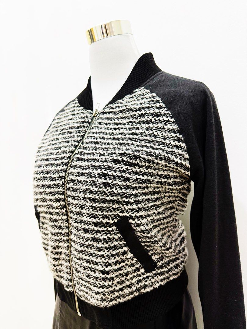 Black & White Tweed Bomber Jacket with Leather Sleeves (Category: Coats, Jackets and Outerwear) located in Manila. Submitted by e.louise (Listing ID 1464332864, Image 2). Description: - Stylish bomber jacket - Textured black and white tweed front - Black sleeves - Zipper closure - Functional pockets - Ribbed collar, cuffs, and hem - Ideal for layering - Versatile styling with jeans or skirts.