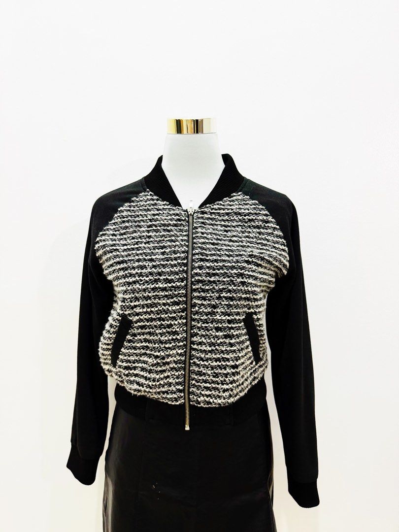 Black & White Tweed Bomber Jacket with Leather Sleeves (Category: Coats, Jackets and Outerwear) located in Manila. Submitted by e.louise (Listing ID 1464332864, Image 3). Description: - Stylish bomber jacket - Textured black and white tweed front - Black sleeves - Zipper closure - Functional pockets - Ribbed collar, cuffs, and hem - Ideal for layering - Versatile styling with jeans or skirts.