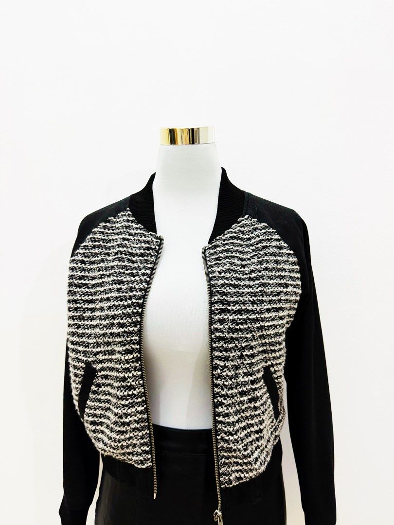 Black & White Tweed Bomber Jacket with Leather Sleeves (Category: Coats, Jackets and Outerwear) located in Manila. Submitted by e.louise (Listing ID 1464332864, Image 1). Description: - Stylish bomber jacket - Textured black and white tweed front - Black sleeves - Zipper closure - Functional pockets - Ribbed collar, cuffs, and hem - Ideal for layering - Versatile styling with jeans or skirts.
