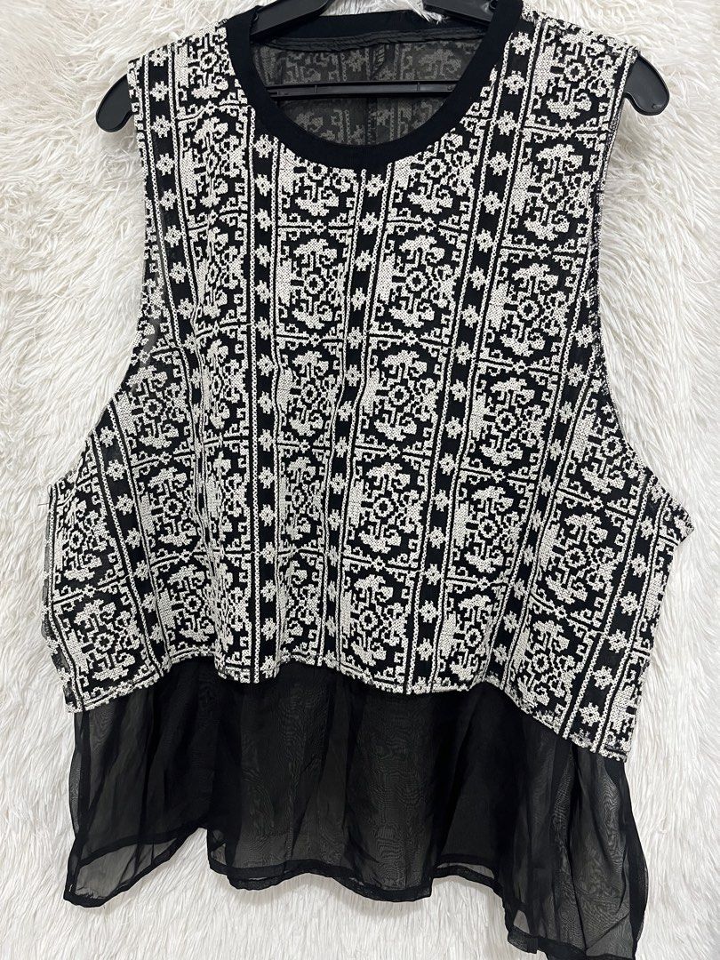 Black and White Patterned Sleeveless Top with Sheer Hem (Category: Sleeveless) located in Imus. Submitted by nomsthriftshop (Listing ID 1464216789, Image 1). Description: - Sleeveless top - Unique black and white geometric pattern - Sheer black fabric hem for a flowy effect - Versatile for layering or wearing alone - Easy to style for casual or dressier outfits.