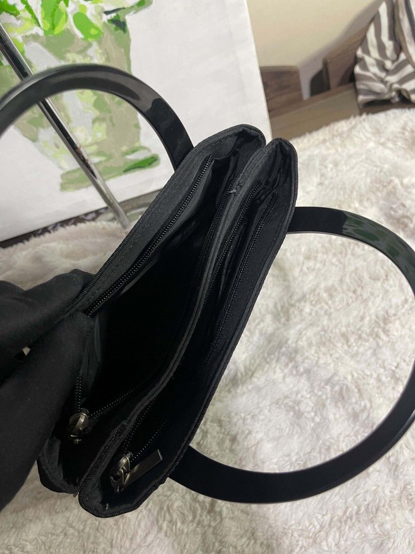 Black Fabric Handbag with Glossy Handles (Category: Tote Bags) located in Naawan. Submitted by twilly.apparel2 (Listing ID 1464222551, Image 3). Description: - Classic black fabric handbag - Unique textured ribbon design on the front - Two glossy black handles - Multiple zippered compartments inside for organization - Versatile for daily use or special occasions - Clean and simple design.