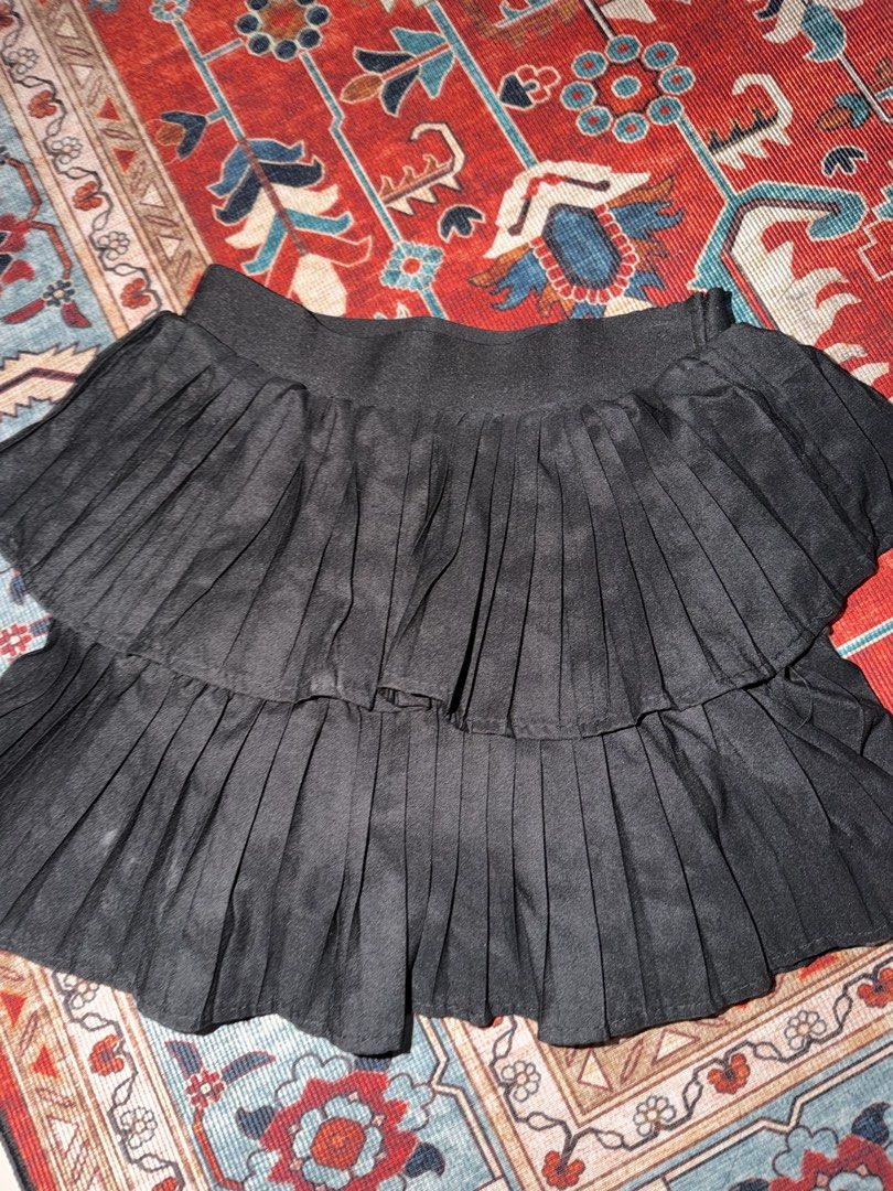 Black Pleated Tiered Mini Skirt (Category: Skirts) located in Manila. Submitted by hihiyana (Listing ID 1464296227, Image 1). Description: - Black pleated mini skirt - Two-tiered design - Comfortable elastic waistband - Estimated size: Medium - Versatile for casual or dressed-up outfits - Easy to style with various tops and shoes.