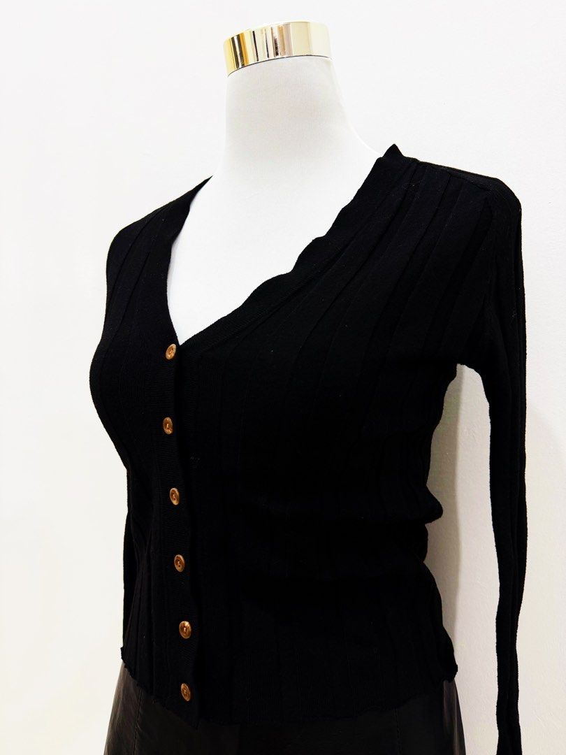 Black Ribbed Button-Up V-Neck Cardigan (Category: Coats, Jackets and Outerwear) located in Manila. Submitted by e.louise (Listing ID 1464333232, Image 2). Description: - Classic black cardigan - Ribbed texture all over - V-neckline with button-up front - Long sleeves - Versatile for layering - Pairs well with jeans or skirts.