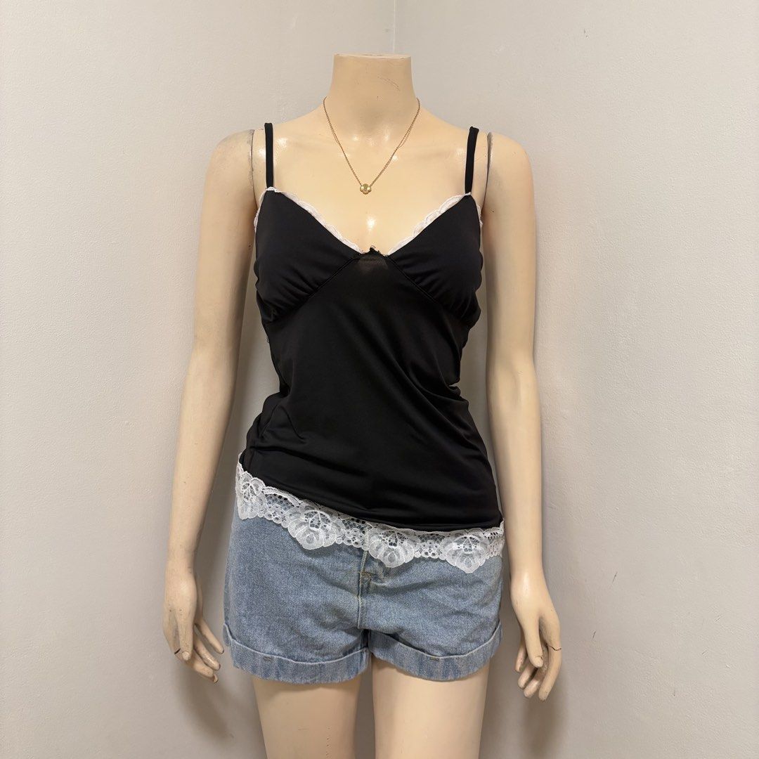 Black Sleeveless Assymetrical Lace Top (Category: Sleeveless) located in Imus. Submitted by reloved.nd (Listing ID 1464258395, Image 1). Description: - Cute black camisole top - Features delicate white lace trim on neckline and hem - Adjustable spaghetti straps for a perfect fit - Easily pairs with shorts or jeans - Ideal for wearing alone or as a layering piece.