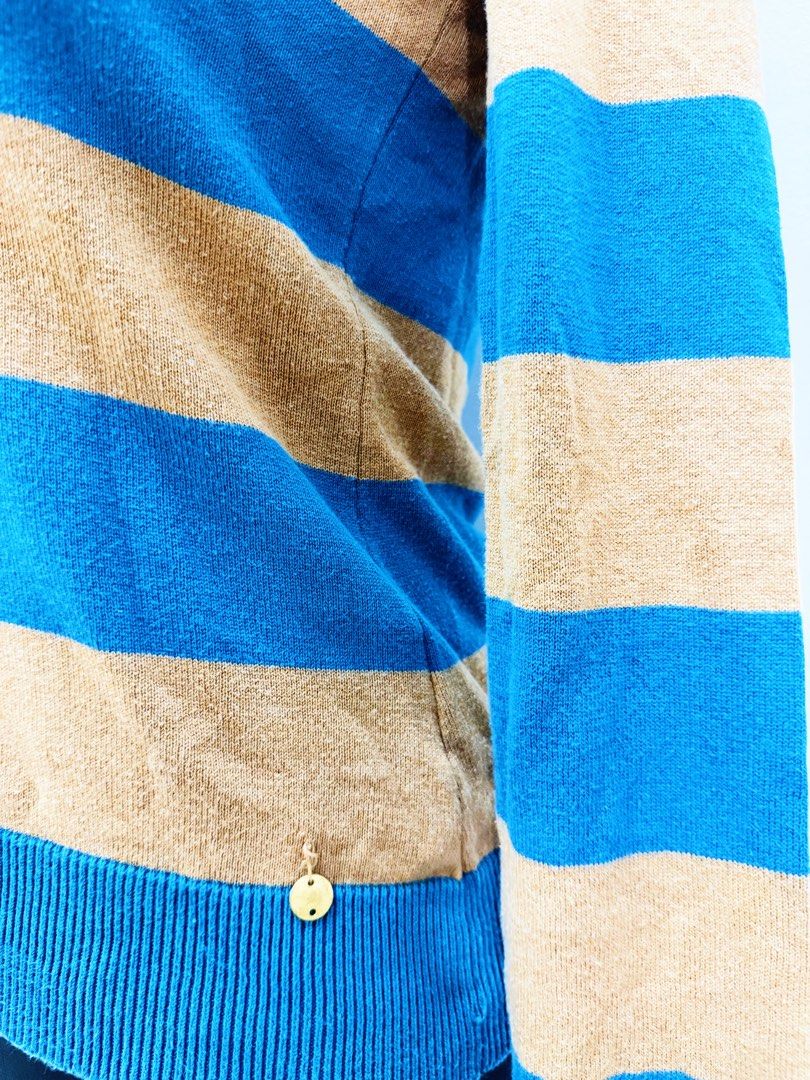 Blue and Tan Striped Long Sleeve Sweater (Category: Longsleeves) located in Manila. Submitted by e.louise (Listing ID 1464332886, Image 2). Description: - Blue and tan striped long sleeve sweater - Classic crew neck design - Ribbed cuffs and hem for a snug fit - Subtle gold charm detail near the hem - Versatile for layering or standalone wear.