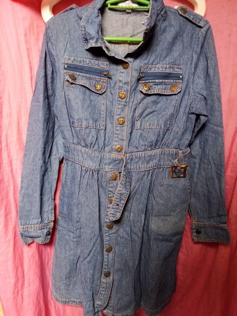 Blue Denim Button-Up Dress with Belt (Category: Dresses) located in Quezon City. Submitted by freedeer.8 (Listing ID 1464165414, Image 1). Description: - Classic blue denim dress - Collared neckline with button-up front - Includes matching fabric belt to cinch the waist - Two chest pockets with zip details - Two flap pockets below - Long sleeves with button cuffs - Ideal for casual wear.