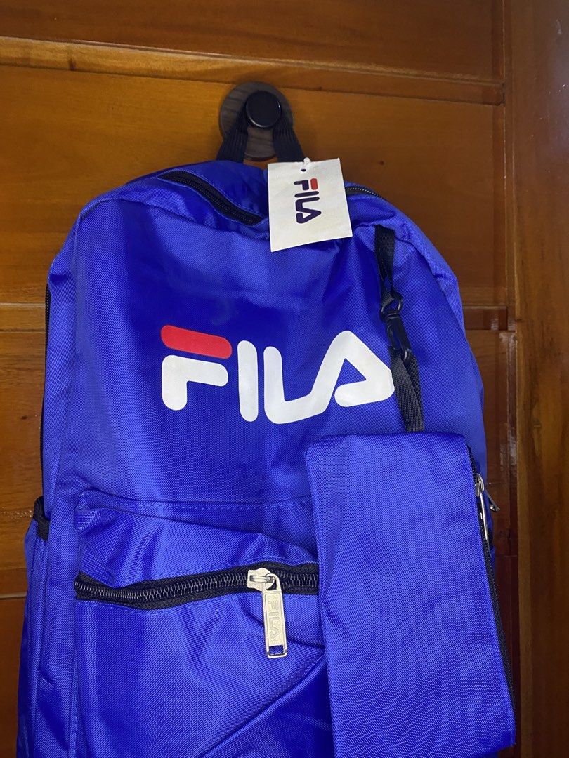 Blue Fila Backpack with Pouch (Category: Backpacks) located in Manila. Submitted by heath2600 (Listing ID 1464299847, Image 2). Description: - Classic blue Fila backpack - Large main compartment - Front zip pocket - Detachable front pouch included - Durable material - Simple and functional design - Perfect for school or everyday use.